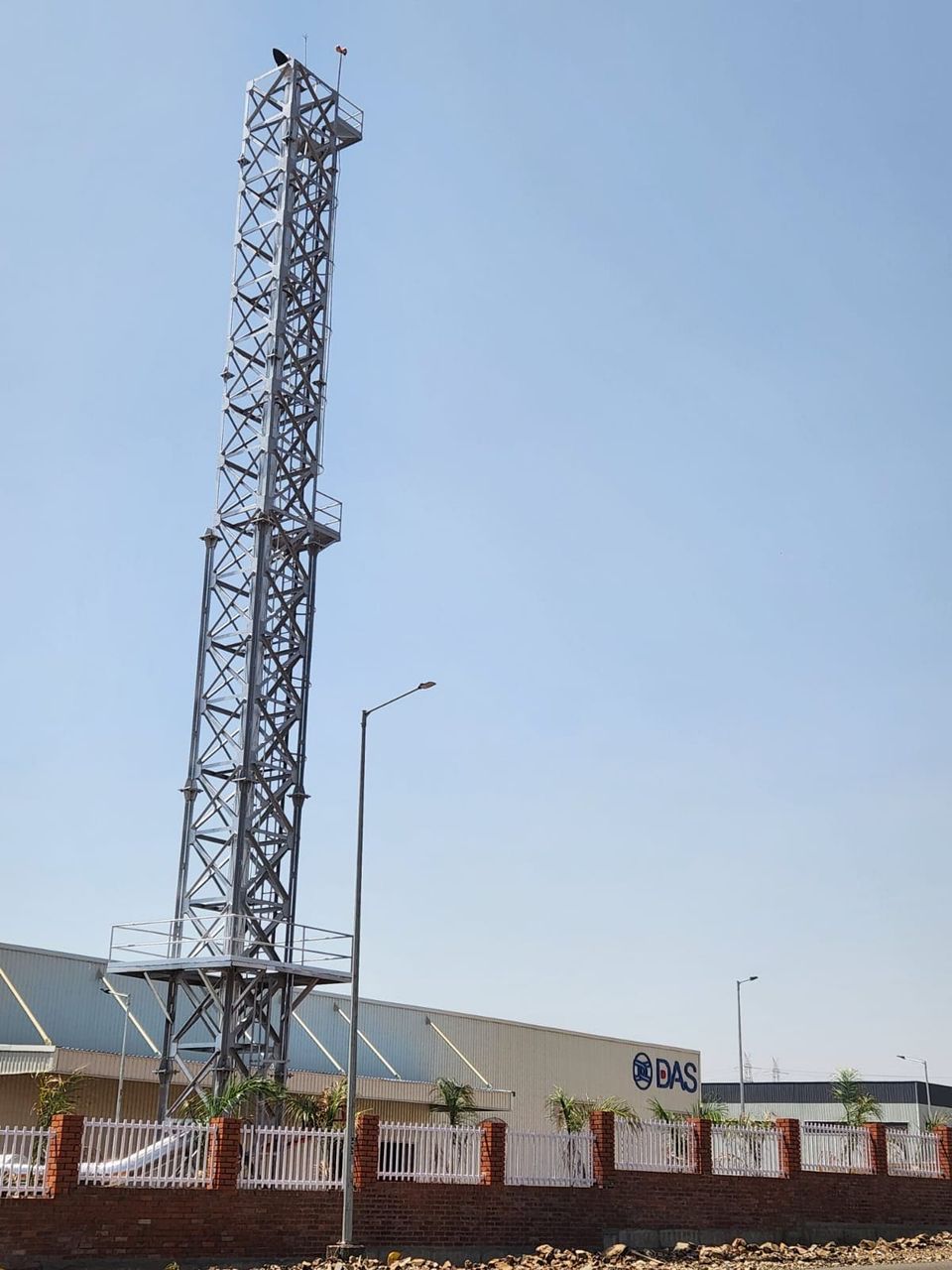 Completed 30 metre lattice stack beside the DAS Auto plant building with its signage