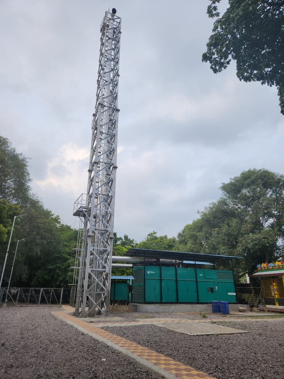 Completed 30 metre galvanised lattice stack beside a 1500 kVA DG acoustic enclosure