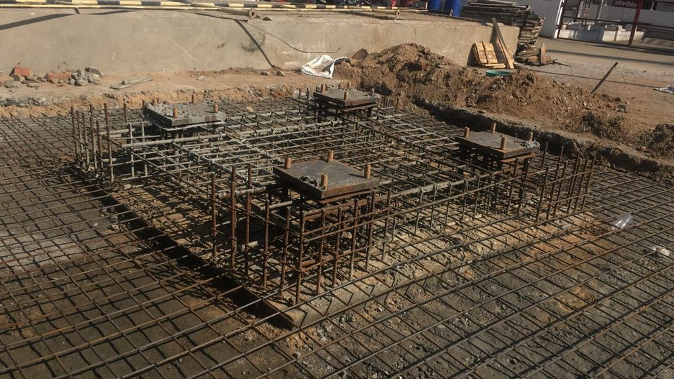 Raft reinforcement and anchor-bolt cages with base-plate templates for a 30 metre stack foundation